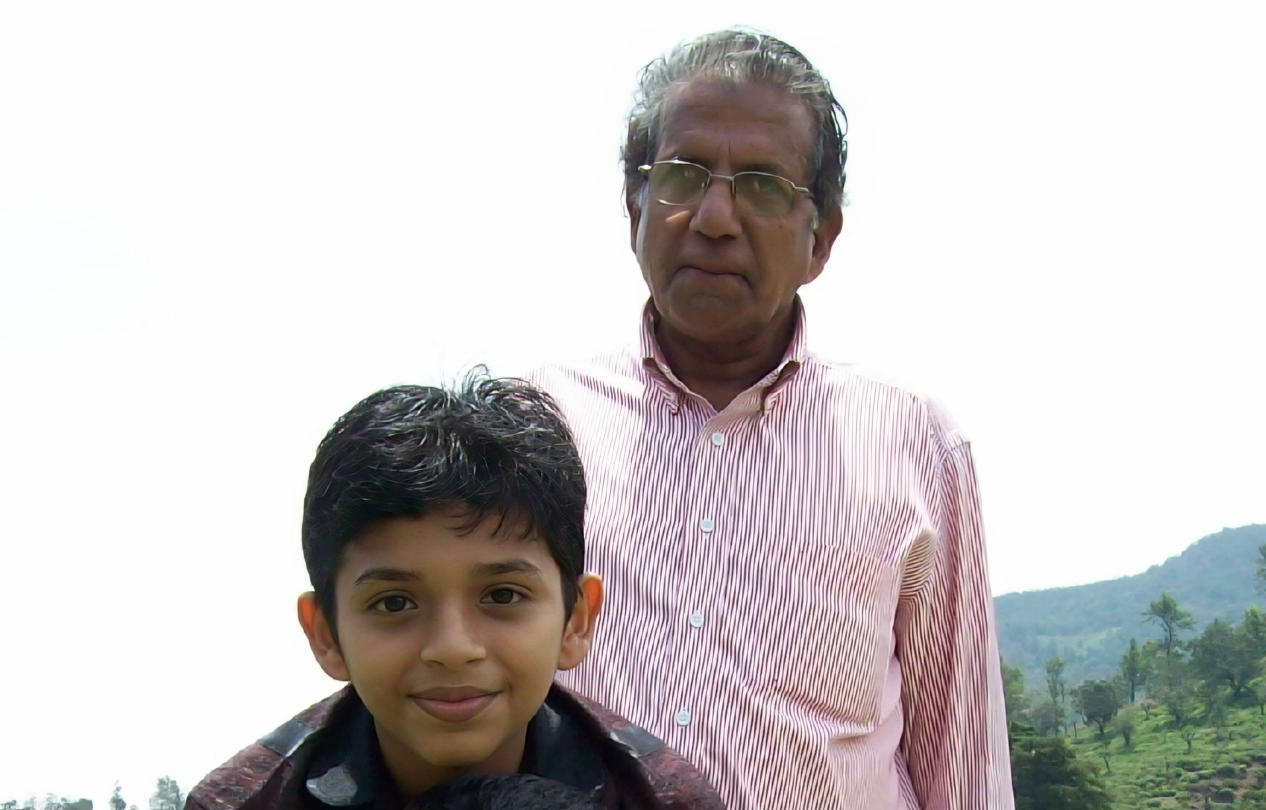 Shibil as a child with his grandfather outdoors